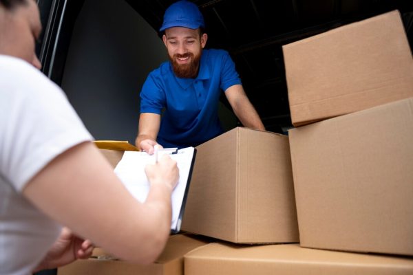 close-up-delivery-man-with-boxes_23-2149035950